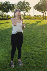 Beautiful young girl playing with a bubble blower.