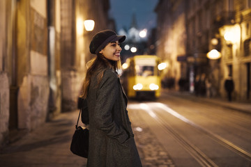 Fototapeta na wymiar portrait of young beautiful fashionable brunette woman posing in street at autumn.