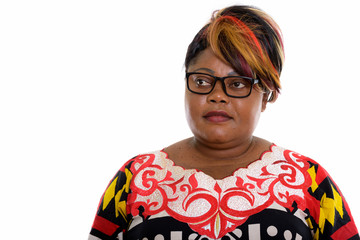 Studio shot of fat black African woman wearing eyeglasses while 