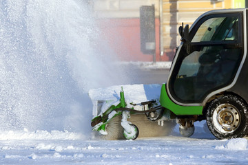 street cleaning the city from snow with the help of special machinery