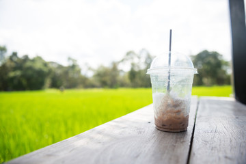 Ice chocolate on a wooden walkway.