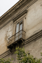 Fototapeta na wymiar Window with balcony in shabby streets of Naples Italy