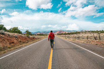 Fototapeta na wymiar Man walking on road in Utah