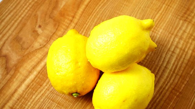 Lemons on a wooden board.	Healthy food.