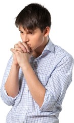 Young man deep in thought with his arms folded
