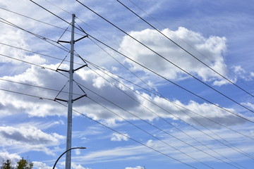 electricity pylon against blue sky