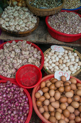 Farmers market stall selling fresh eggs and garlic