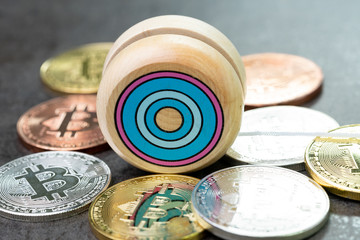 Bitcoin market price yoyo effect, swing up and down, cryptocurrency risk metaphor, wooden yo-yo toy with physical bitcoin coins on dark black cement background
