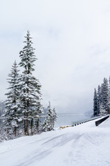 Snowy Bridge Over Mountain Lake in WInter
