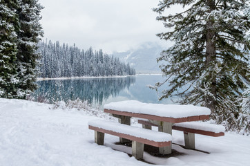 Picnic Table Beside Mountain Lake After Fresh Snowfall