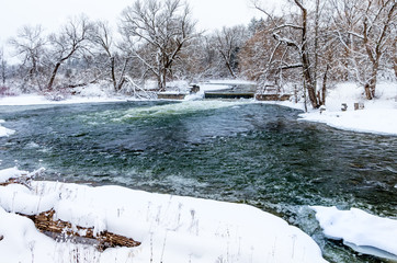 Rushing River in Early Winter Snowfall