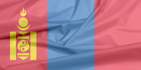 Fabric flag of Mongolia. Crease of Mongolian flag background, red and blue with the Soyombo symbol centred on the hoist-side of the red band.