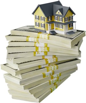 Stack of money with house on white isolated background
