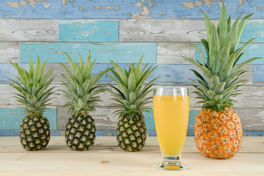 natural fresh fruit and juice of pineapple on wooden background