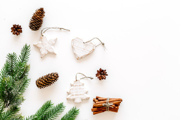 Decoration for winter holidays concept. Christmas, New year. Spruce branch, cones and toys on white background top view space for text
