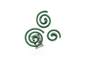 Mosquito repellent for outdoor: garden, summer house, picnic. Green spiral on white background top view copy space pattern