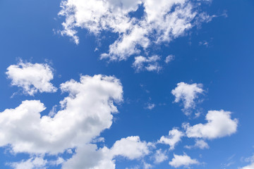 Blue sky background with white clouds, rain clouds.