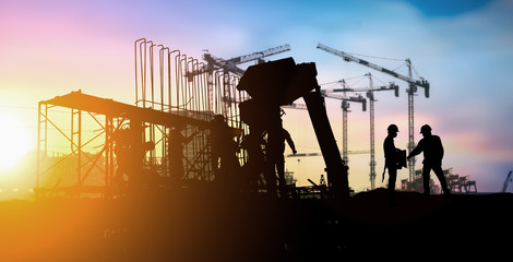 Silhouette of engineer and construction team working at site over blurred background for industry background with Light fair.Create from multiple reference images together.