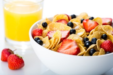 Bowl of Cornflakes, Blueberries, Strawberries and Orange Juice