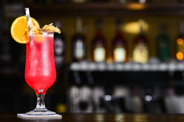 Strawberry Colada. Red cocktail on the bar. Decorated glass of coctail on the bar table.