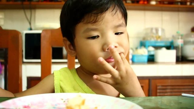 Thai child eating food on the table