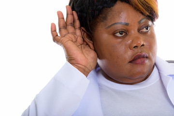 Close up of fat black African woman doctor listening while think