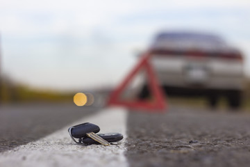 lost car keys lying on the roadway, on a blurred background with bokeh effect