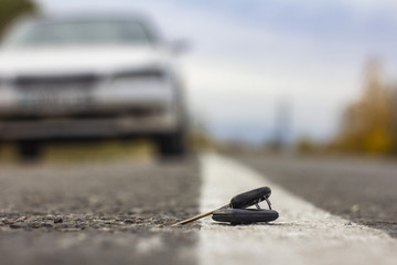 lost car keys lying on the roadway, on a blurred background with bokeh effect