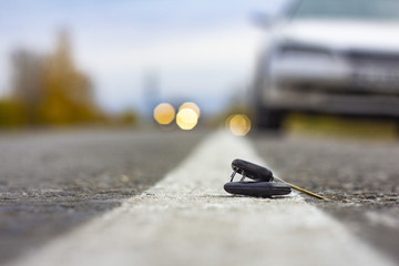 lost car keys lying on the roadway, on a blurred background with bokeh effect