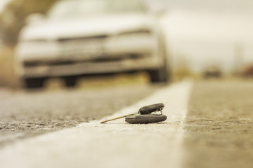 lost car keys lying on the roadway, on a blurred background with bokeh effect