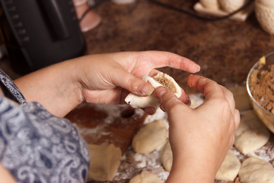 homemade cakes of the dough in the women's hands. The process of making pies with meat and potatoes dough by hand