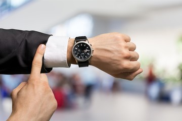 Businessman with hand watch on background