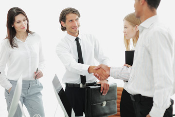 handshake between lawyer and client in a modern office