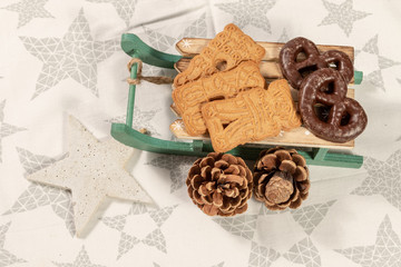Golden christmas speculoos on wooden sleigh