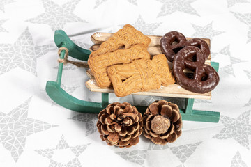 Christmas cookies on wooden sleigh as christmas decoration