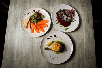 assorted fish dishes of mackerel, salmon, and trout