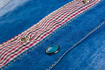 Blue washed faded jeans texture with seams, clasps, buttons and rivets
