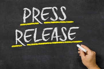 Press Release written on a blackboard