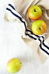 Ripe apples wooden white background top view