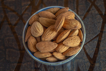Almonds kept on a desk California Almonds in a bone Chinaware