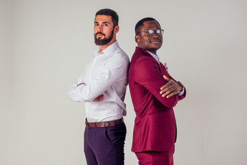 Two confident business men talking high five teamwork international company good deal.afro american and european man in studio on white background