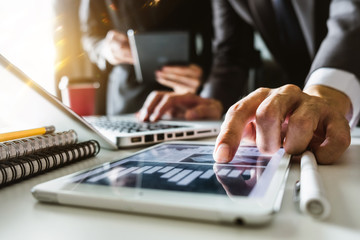 Business team meeting. professional investor working new start up project. Finance task. with smart phone and laptop and digital tablet computer  in morning light