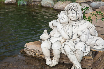 Fototapeta na wymiar Photo of statues of a boy and a girl