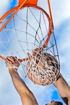 Hanging on Basketball Hoop After Slam Dunk Close-Up