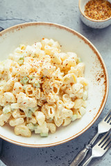 Dinner dish a pasta salad with cheese and celery.