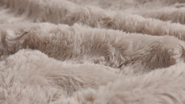 Slow pan over brown blanket made of faux fur fleece 4K video