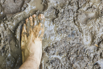 A barefoot aerial view on mud surface in the forest