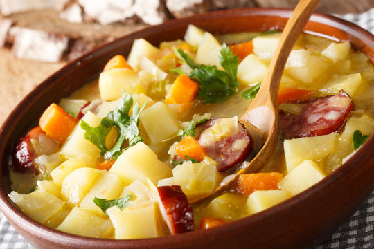 Slow cooker German potato soup (kartoffelsuppe) close-up on a plate. horizontal