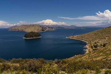 Terraced landscape of Isla del Sol with Andes mountains in the background on the Bolivian side of Lake Titicaca