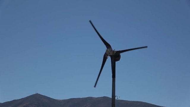Handheld video of a lone windmill prop dramatic zoon and close up
